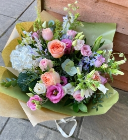 Luxury pastels hand tied bouquet presented in a gift box in water.